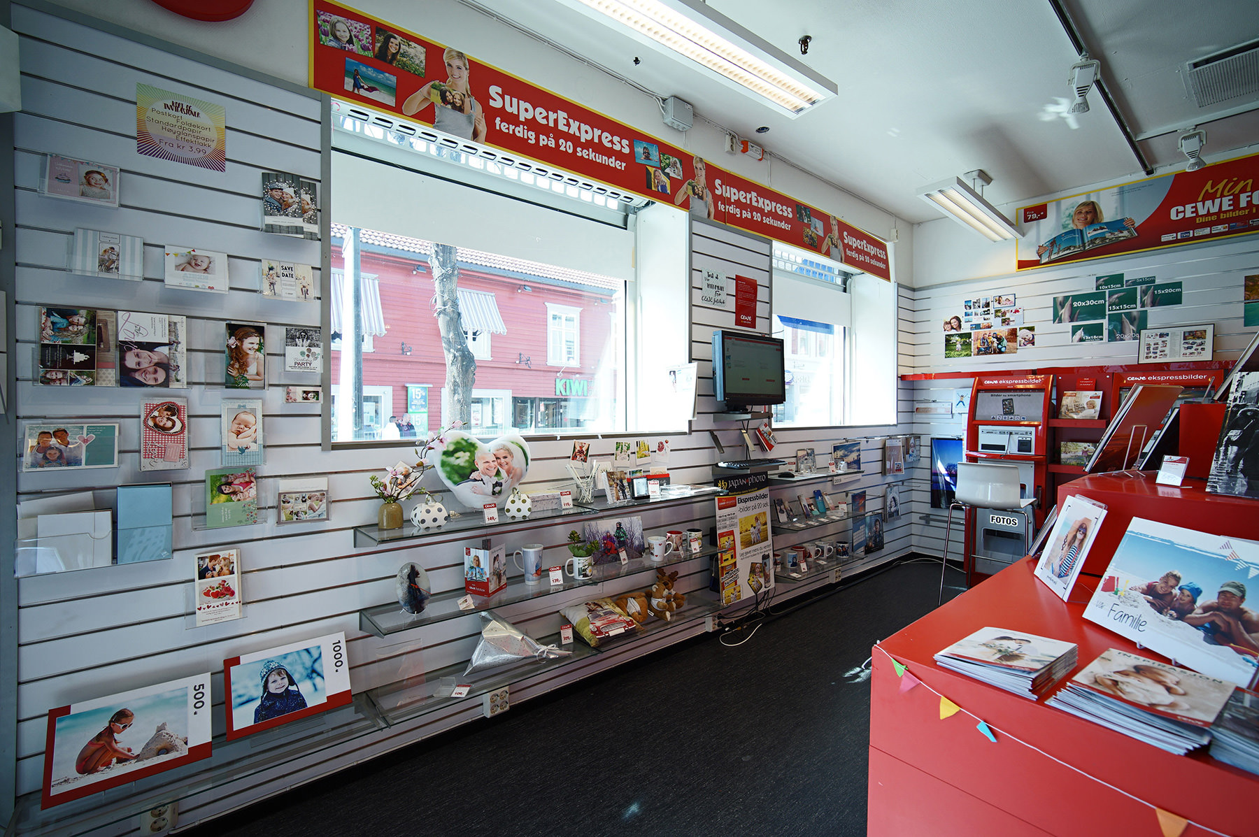 Lyst og innbydende butikkinteriør med hyller fylt med fotoprodukter og gaveartikler