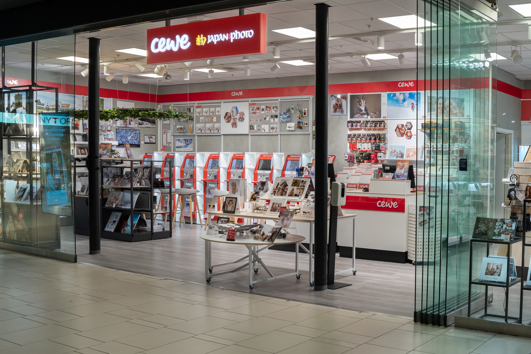 En lys og moderne CEWE Japan Photo-butikk med selvbetjente fotostasjoner, gaveutstillinger og inspirerende fotoprodukter