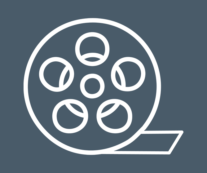 Filmspole med fem runde hull og en stripe film som henger ut på høyre side Filmspole med fem runde hull og en stripe film som henger ut på høyre side